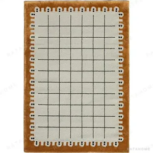 Custom Dotted Edge Grid Rug in Cream and Amber — in a room setting