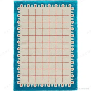 Custom Dotted Edge Grid Rug in Cream, Coral and Teal — in a room setting