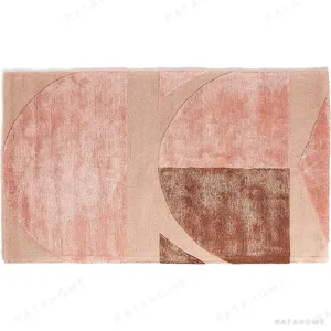 Custom Blush Arch Panel Rug with Tonal Blocks in rose stone — in a room setting