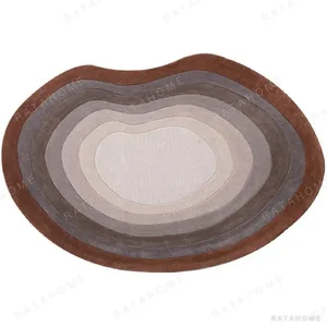 Custom Kidney Contour Rug in Rust, Taupe and Cream — in a room setting