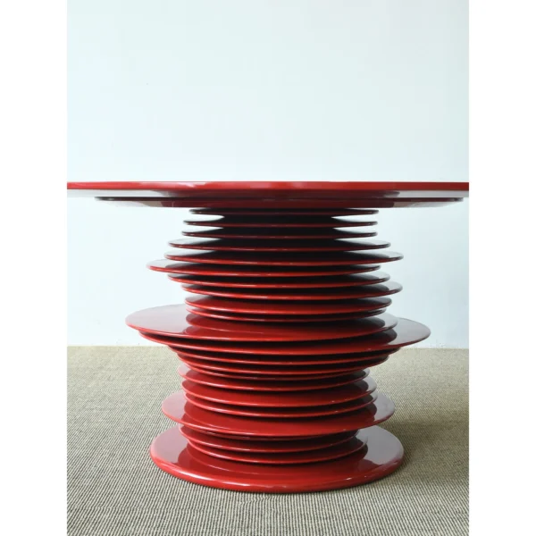 Red High-Gloss Stacked-Disc Round Table in red — in a room setting
