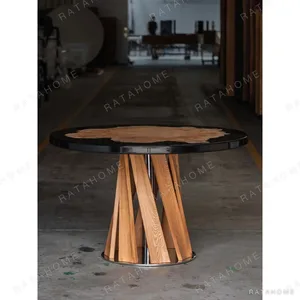 Burl and Black Resin Round Dining Table on Twisted Wood Base in black — in a room setting