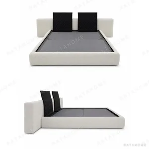 Custom Low Upholstered Bed with Bolster Cushions in oatmeal — in a room setting