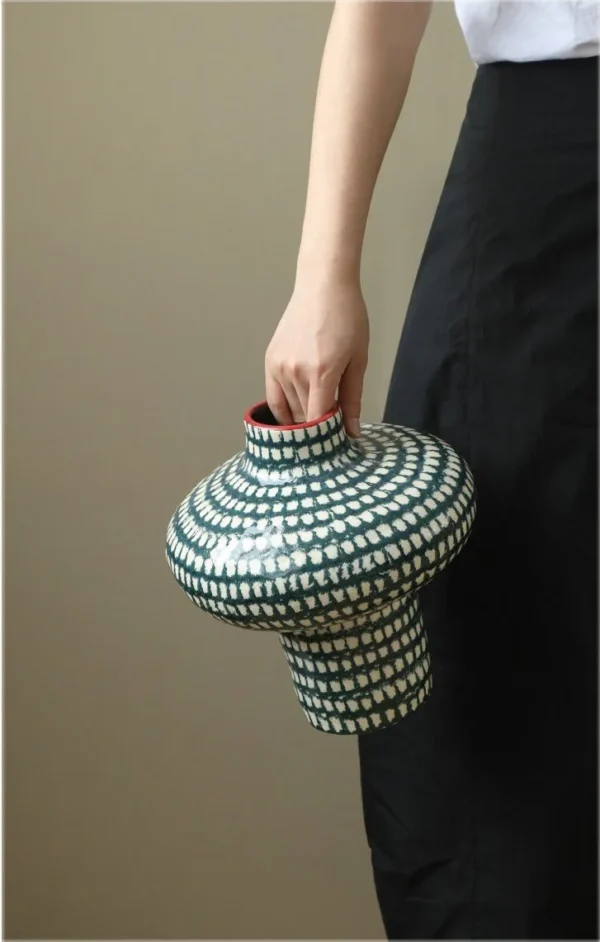 Artist-Made Teal Grid Spinning-Top Vase with Red Rim, Medium in olive — in a room setting