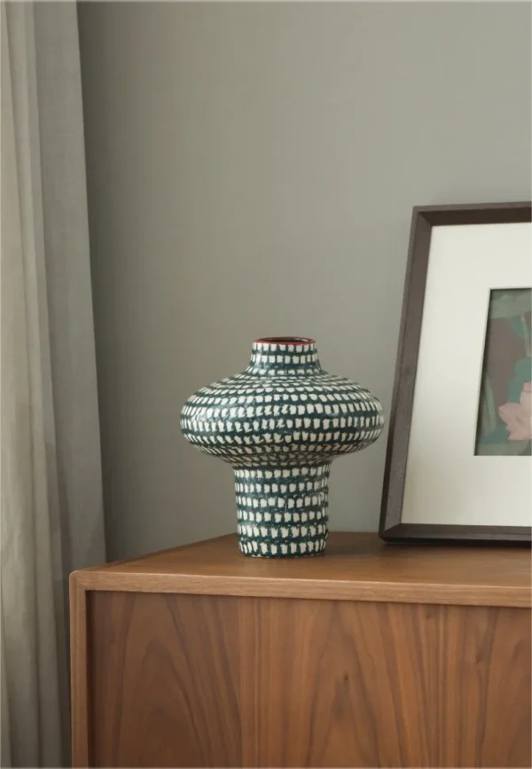 Artist-Made Teal Grid Spinning-Top Vase with Red Rim, Medium in olive — in a room setting