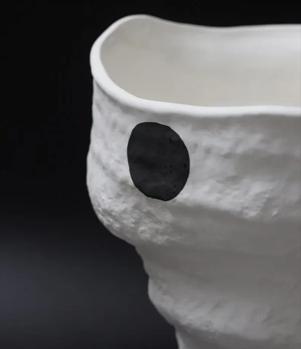 Designer Jingdezhen White Folded Vase with Black Spots in ivory — in a room setting