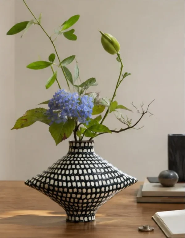Artist-Made Hand-Painted Checkered Lens Vase in black — in a room setting