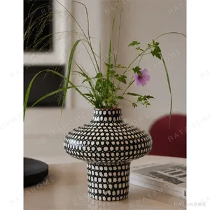 Artist-Made Hand-Painted Grid Mushroom Vase for TV Consoles in black — in a room setting