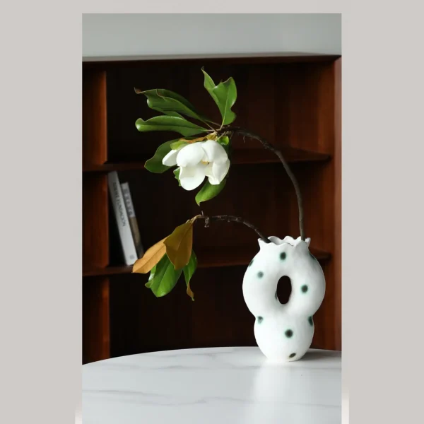 Artist-Made Hand-Pinched Pierced Vase with Green Moss Dots in ivory — in a room setting
