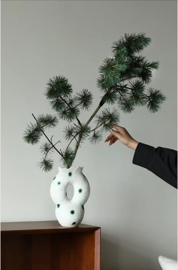 Artist-Made Hand-Pinched Pierced Vase with Green Moss Dots in ivory — in a room setting