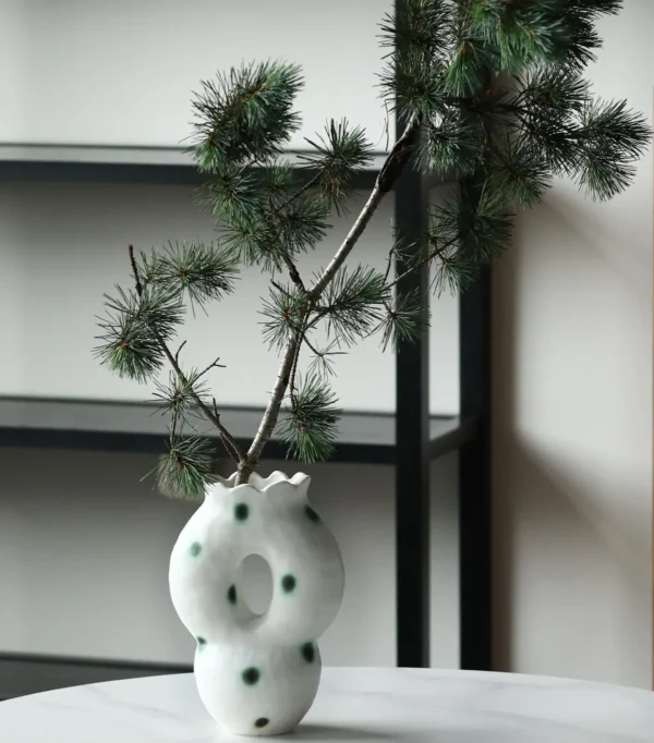 Artist-Made Hand-Pinched Pierced Vase with Green Moss Dots in ivory — in a room setting