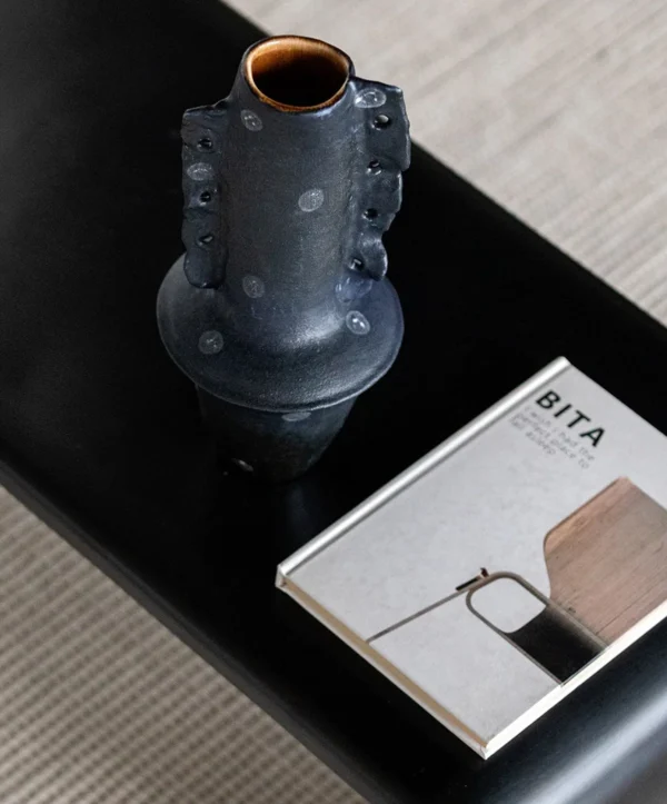 Artist-Made Hand-Pinched Black Stone Sculptural Vase in black — in a room setting