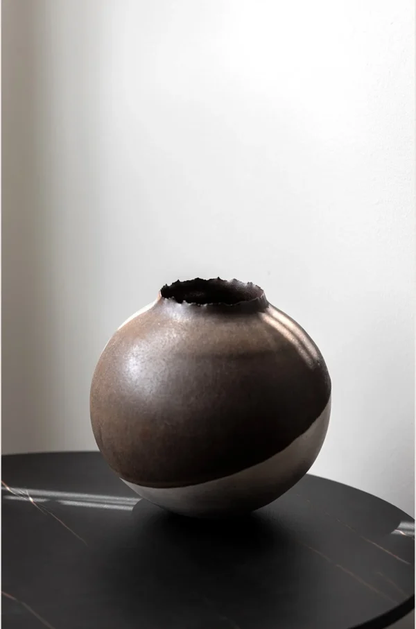 Artist-Made Round Vase with Silver Torn Rim and Bronze Body in clay — in a room setting