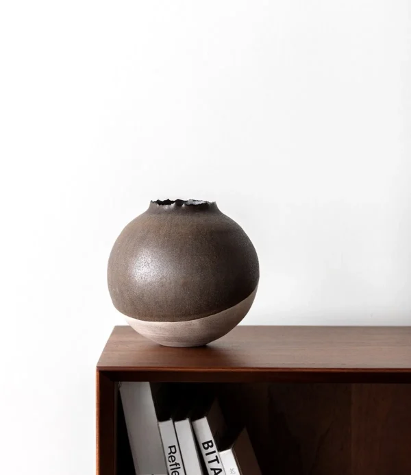Artist-Made Round Vase with Silver Torn Rim and Bronze Body in clay — in a room setting