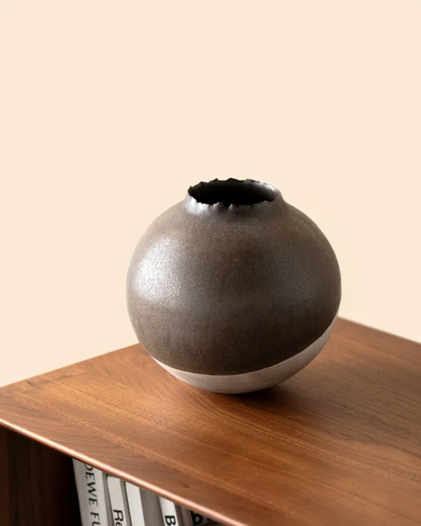 Artist-Made Round Vase with Silver Torn Rim and Bronze Body in clay — in a room setting