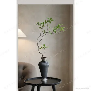 Hand-Thrown Stoneware Vase in black — in a room setting