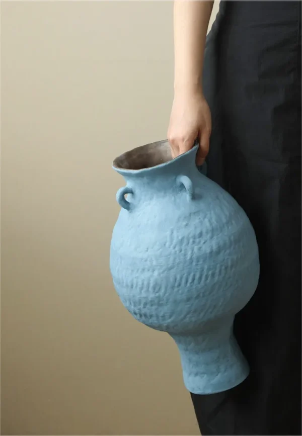 Artist-Made Matte Blue Footed Urn Vase with Ear Lugs, Medium in blue — in a room setting