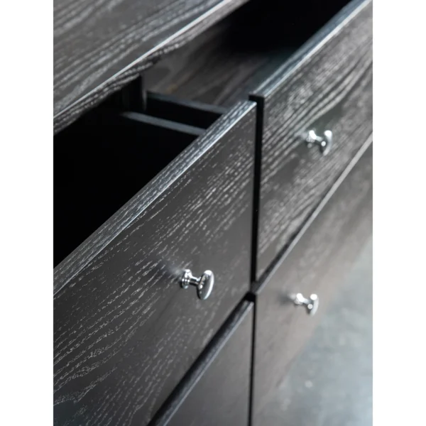 Black Wood-Grain Four-Drawer Chest with Silver Knobs in black — in a room setting