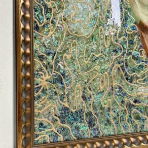 Coral Abstract Wall Art on Teal Ground in Gold Frame — in a room setting
