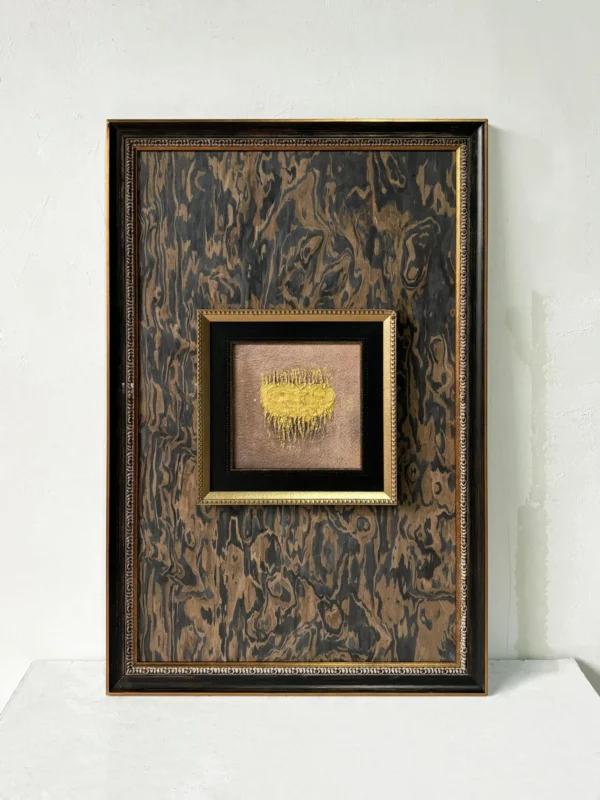 Small Gold Marbled Wall Art in Dark Frame — in a room setting