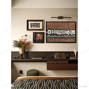 Rust Textured Wall Art Set of 3 with Picture Light in rust — in a room setting