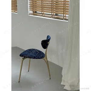 Deep Blue Velvet Petal-Back Chair on Brass Tripod Legs in blue — in a room setting