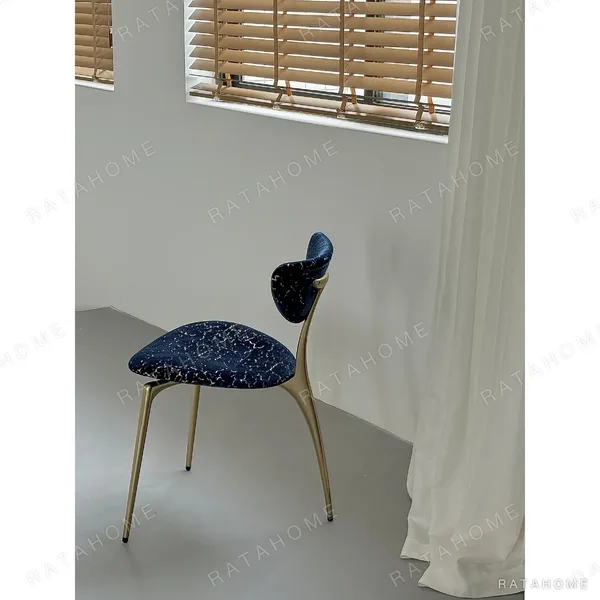 Deep Blue Velvet Petal-Back Chair on Brass Tripod Legs in blue — in a room setting