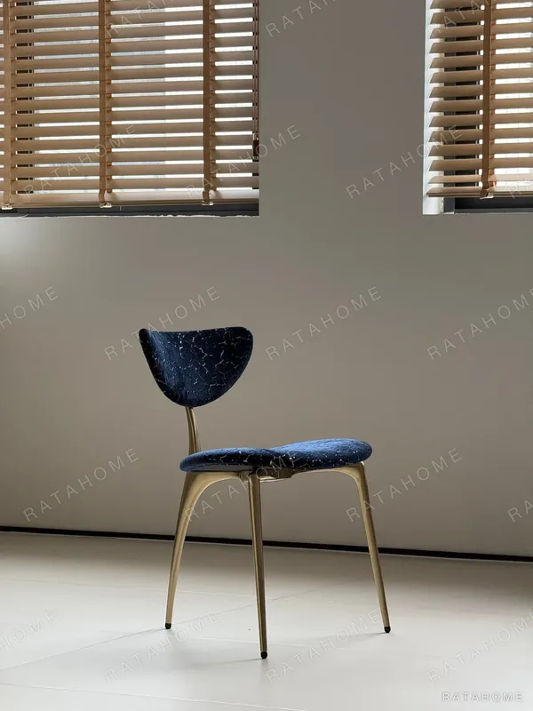 Deep Blue Velvet Petal-Back Chair on Brass Tripod Legs in blue — in a room setting