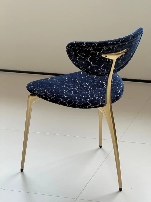 Deep Blue Velvet Petal-Back Chair on Brass Tripod Legs in blue — in a room setting