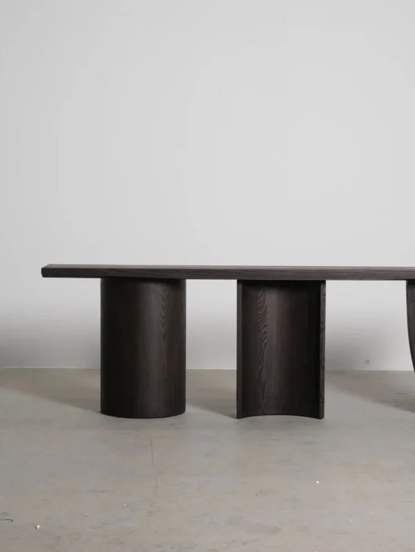 Three-Curve Ash Console Table in walnut — in a room setting