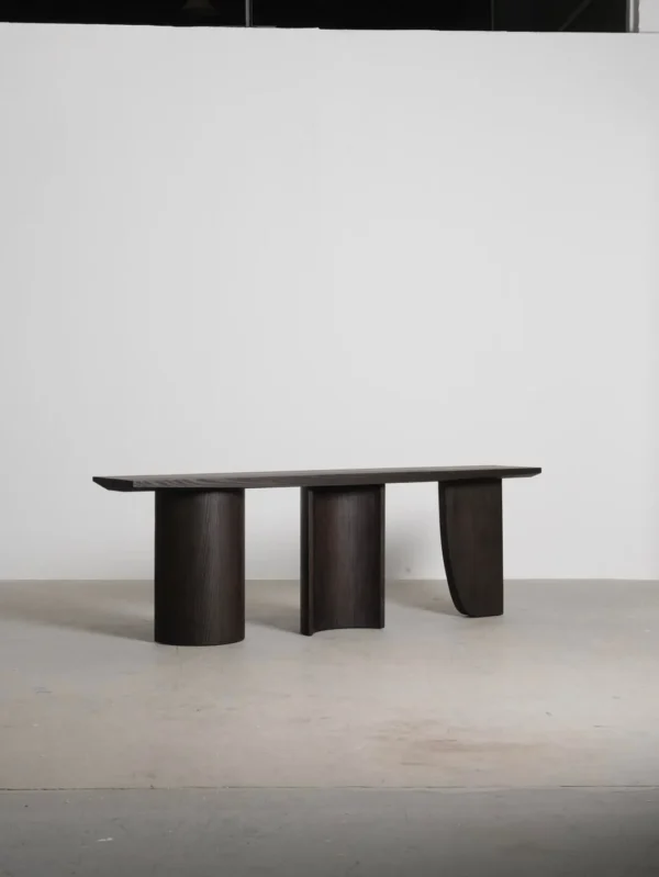 Three-Curve Ash Console Table in walnut — in a room setting