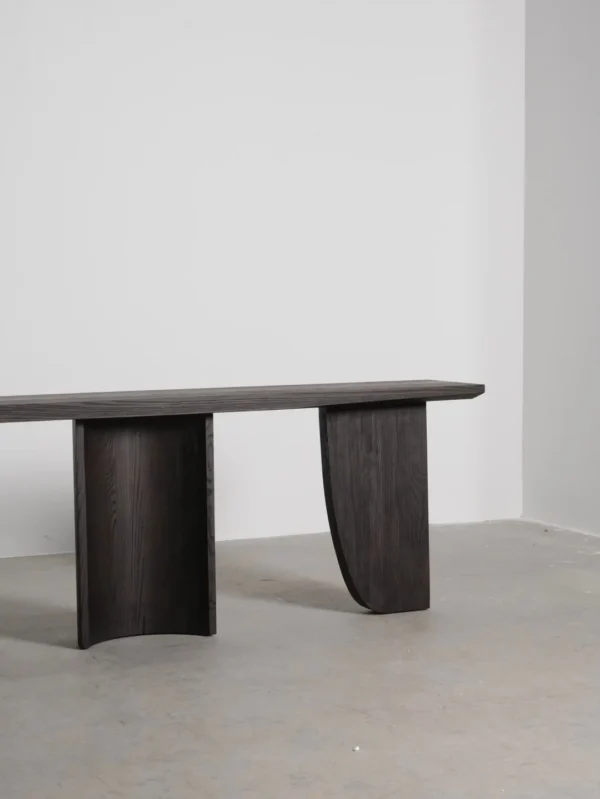 Three-Curve Ash Console Table in walnut — in a room setting