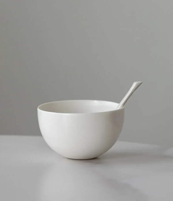 Designer Hand-Made Plain White Ceramic Rice Bowl in ivory — in a room setting