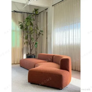 Gently Curved Modular Sofa in rust — in a room setting