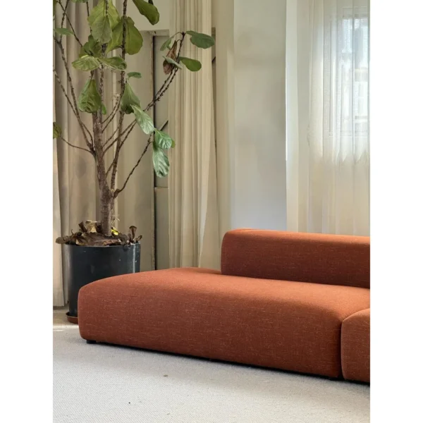 Gently Curved Modular Sofa in rust — in a room setting