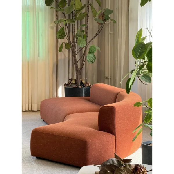 Gently Curved Modular Sofa in rust — in a room setting