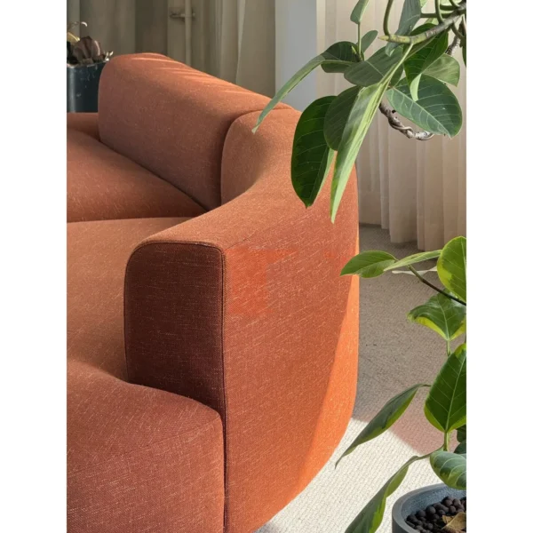 Gently Curved Modular Sofa in rust — in a room setting