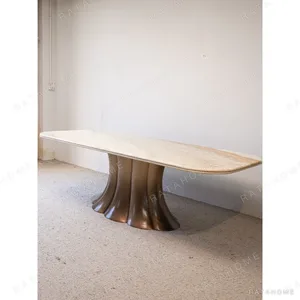 Travertine Dining Table on Bronze Flared Pedestals in oatmeal — in a room setting
