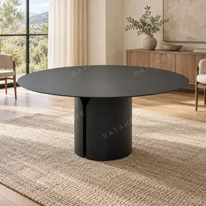 Black Round Dining Table on Split Cylinder Base in black — in a room setting