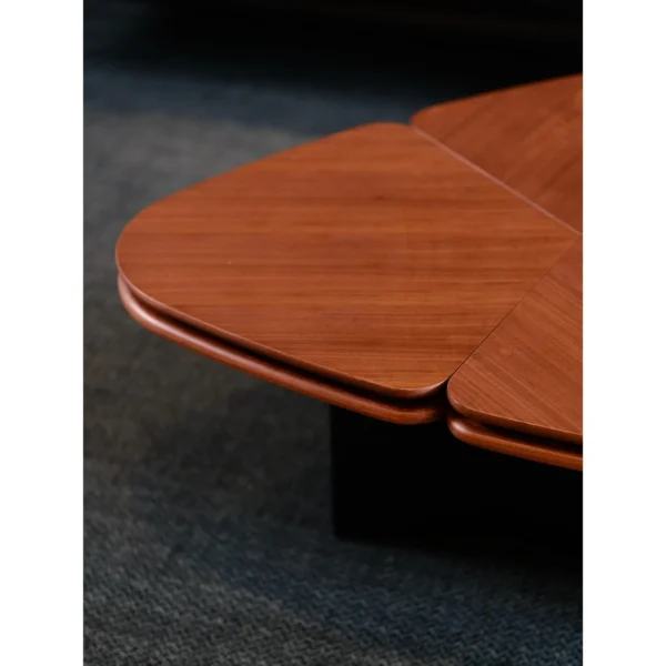 Clover Coffee Table in Vintage-Toned Wood — in a room setting