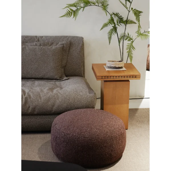Floating Dot Round Pouf in Burgundy Textured Fabric — in a room setting