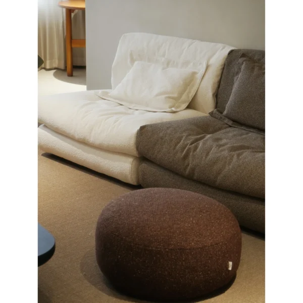 Floating Dot Round Pouf in Burgundy Textured Fabric — in a room setting