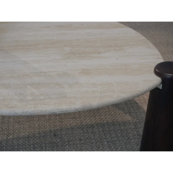 Island Travertine Coffee Table on Dark Wood Cylinder Legs in oatmeal — in a room setting
