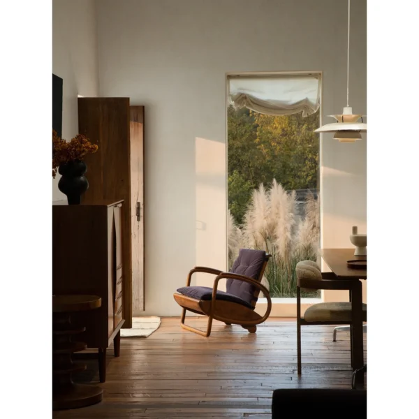 Dragon Boat Teak Lounge Chair with Woven Rattan Seat in clay — in a room setting