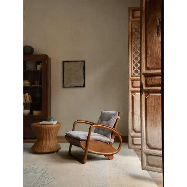 Dragon Boat Teak Lounge Chair with Woven Rattan Seat in clay — in a room setting