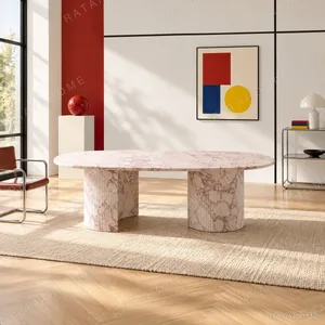 Pink Marble Oval Dining Table on Twin Stone Cylinders in rose stone — in a room setting