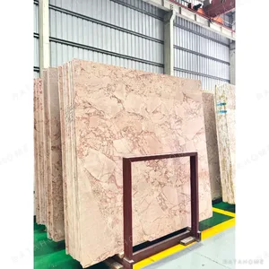Pink Marble Oval Dining Table on Twin Stone Cylinders in rose stone — in a room setting