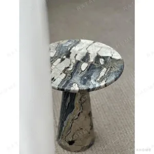 Dusk Light Marble Round Side Table on Cone Base in black — in a room setting