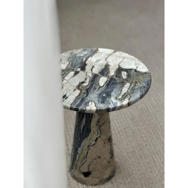 Dusk Light Marble Round Side Table on Cone Base in black — in a room setting