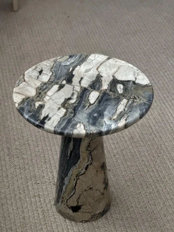 Dusk Light Marble Round Side Table on Cone Base in black — in a room setting